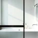 Installation of a stylish shower door black frame enhances a modern bathroom's elegance.