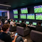 Kqbd hôm nay in vibrant sports betting lounge, fans engaged in live match analysis on mobile devices.
